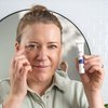 Photo of a woman applying the product.