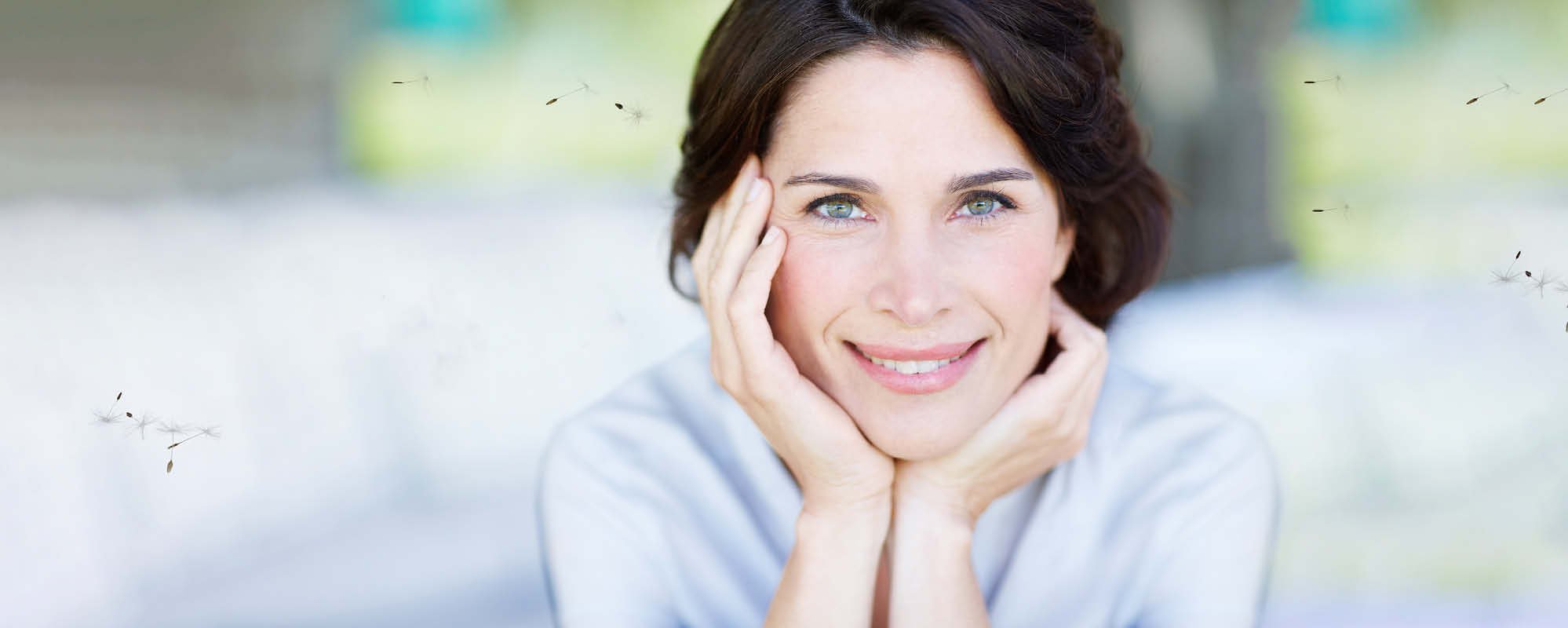 Brunette woman surrounded by pollen